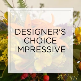 Mixed bouquet of orange and yellow flowers with red berries behind text reading Designer's Choice Impressive