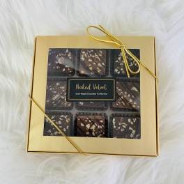 Gold gift box of chocolate truffles tied with a ribbon