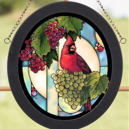 Round hanging stained-glass panel with a red bird and grape clusters