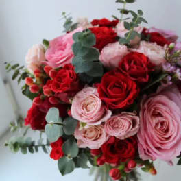Bouquet of red and pink roses with eucalyptus