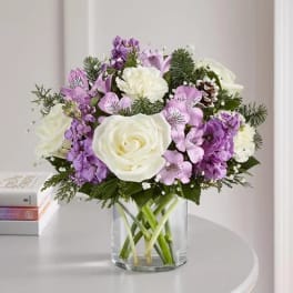 White and lavender bouquet in a clear glass vase