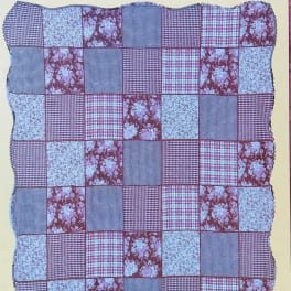 Patchwork quilt with red, blue, and floral fabric squares