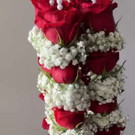 Hanging arrangement of red roses and white baby's breath