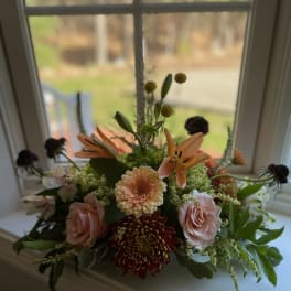 Mixed floral arrangement with pink roses, lilies, and chrysanthemums