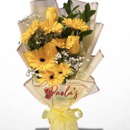 Yellow gerbera bouquet wrapped in cream paper with a yellow ribbon