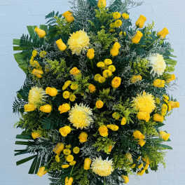 Large yellow floral standing spray with roses and chrysanthemums