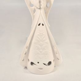 White ceramic angel figurine with cutout wings and patterned gown against a plain background