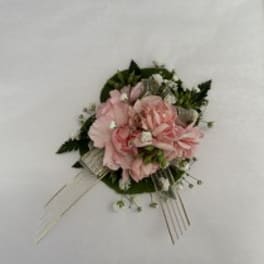 Pink floral corsage with ribbon and pins