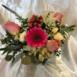 Pink and cream bouquet with a bright gerbera daisy and roses