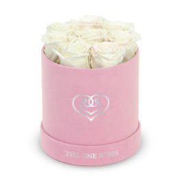 White roses in a pink round box with a heart logo