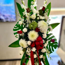 Tall white and red standing spray with large mums and roses on an easel
