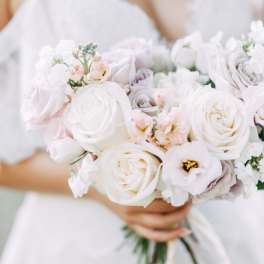 White bridal bouquet of roses and small blush flowers