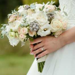 Bride holding a white and blush rose bouquet