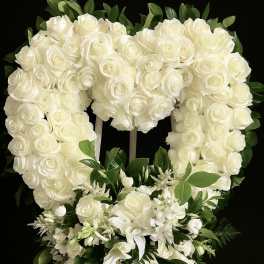 Heart-shaped standing wreath of white roses with cascading white lilies and blooms