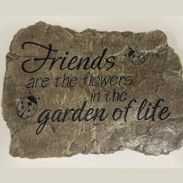 Decorative stone plaque with the quote "Friends are the flowers in the garden of life"
