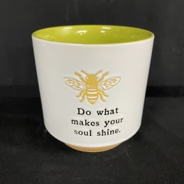 White ceramic pot with a bee graphic and inspirational text