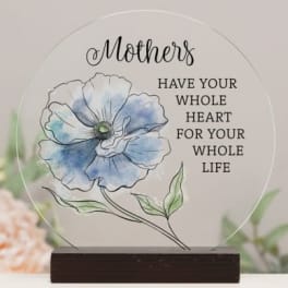 Round glass plaque with a blue flower illustration and Mother's quote