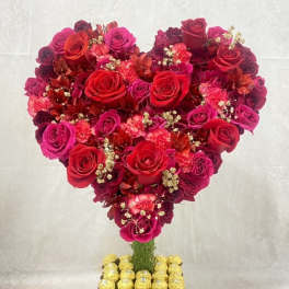 Heart-shaped rose arrangement with Ferrero Rocher chocolates on a square base