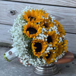 Bouquet of sunflowers and white baby's breath on a wooden stand