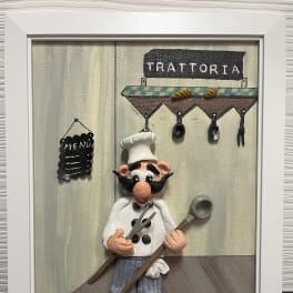 Framed wall art of a cartoon chef in front of a trattoria sign