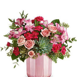 Pink and red mixed bouquet in a pink glass vase