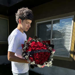 Large bouquet of red roses with baby's breath and a ribbon