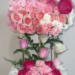Pink and white rose arrangement in a glittery rectangular container