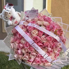 Large pink rose bouquet with a Hello Kitty plush and ribbons