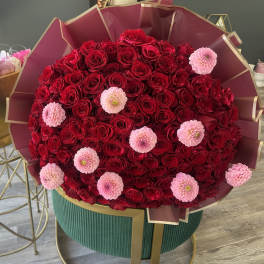 Large bouquet of red roses with pink flowers in burgundy wrap