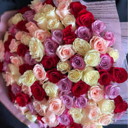 Large bouquet of red, cream, peach, and lavender roses wrapped in pastel paper