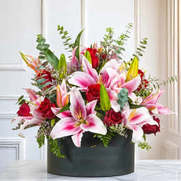Pink lilies and red roses in a black box arrangement