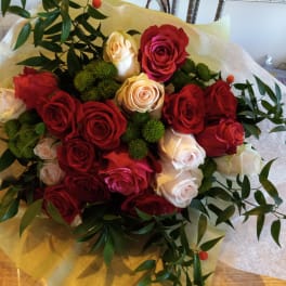 Bouquet of red and white roses with green filler and wrapping paper