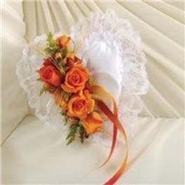 Orange roses with white lace and ribbon on a chair