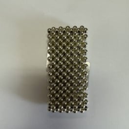 Small rectangular cluster of metallic beads on a light background