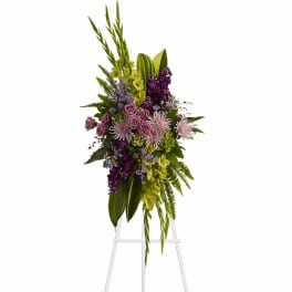 Tall purple and green floral spray on a white easel