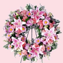 Pink and white floral wreath on a stand