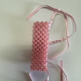 Pink beaded ribbon corsage with satin ties