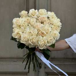 Bouquet of cream roses tied with a white ribbon