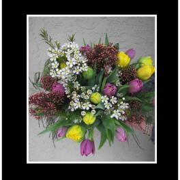 Bouquet of yellow and purple tulips with small white blossoms