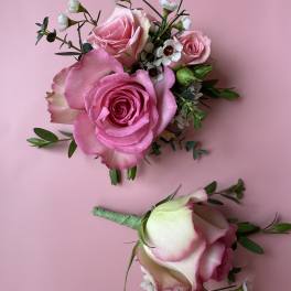 Pink rose bouquet and matching boutonniere on a pink background