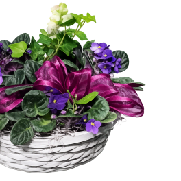 Purple flowers in a white woven basket with a magenta ribbon
