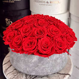 Round box filled with red roses