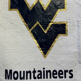Quilted West Virginia Mountaineers logo on white fabric