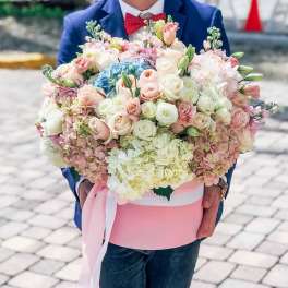 Large pastel bouquet of roses and hydrangeas in a pink box