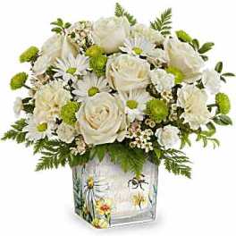 White roses and daisies in a decorated glass vase