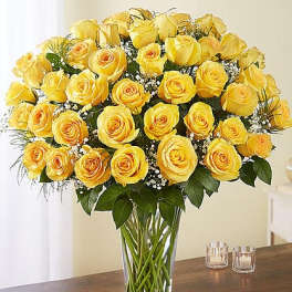 Yellow roses arranged in a clear glass vase