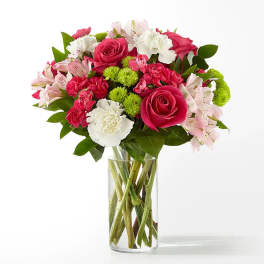 Bouquet of pink and white flowers in a clear glass vase