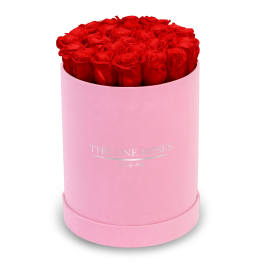 Red roses in a pink round box