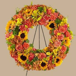 Circular wreath of mixed flowers on a stand