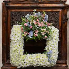 Square floral wreath with white daisies and pastel pink and blue flowers